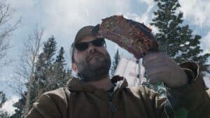 Randy Stavinoha Holding a Rib from the Original Black's Barbecue